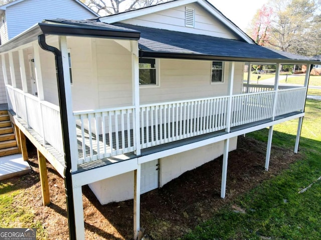 view of home's exterior with a sunroom and roof with shingles