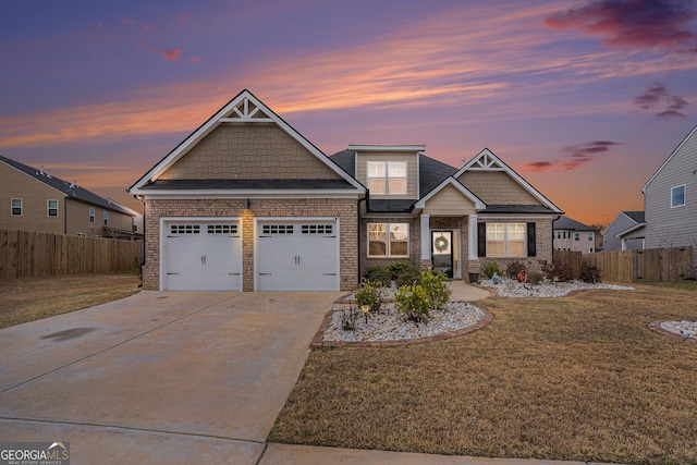 craftsman-style house with an attached garage, a front lawn, fence, and driveway