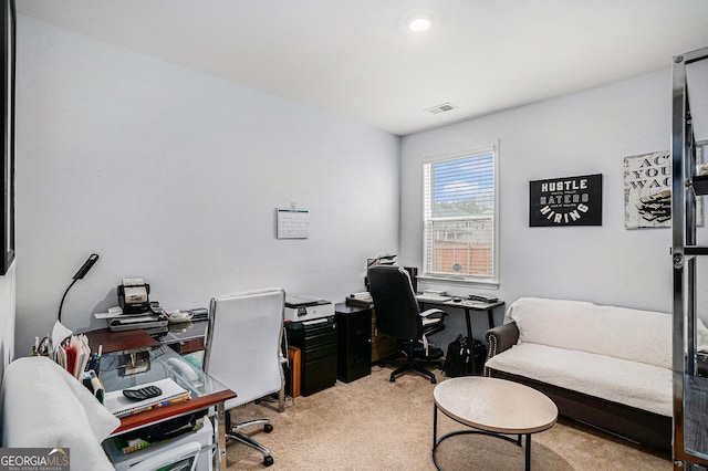 office area with visible vents and light colored carpet