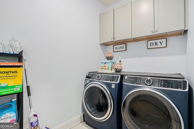 laundry room featuring cabinet space, baseboards, and washer and dryer