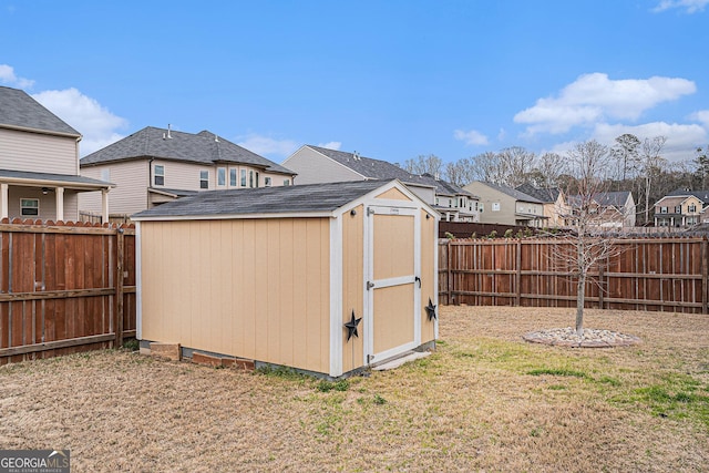 view of shed featuring a residential view and a fenced backyard