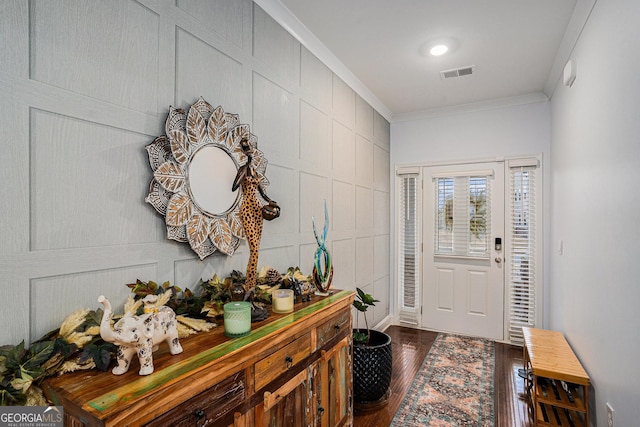 foyer featuring crown molding, dark wood-style flooring, and visible vents