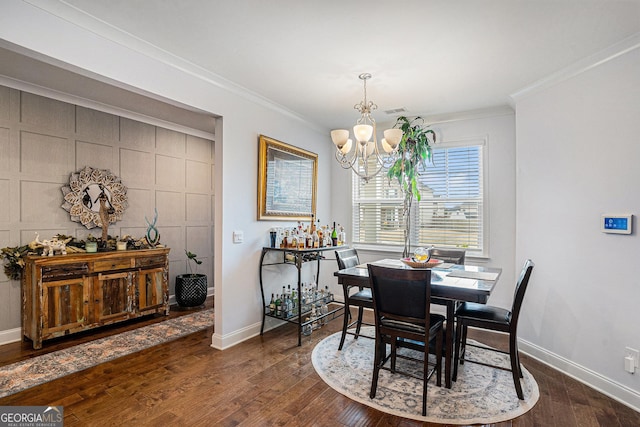 dining room featuring baseboards, ornamental molding, dark wood-type flooring, and a notable chandelier