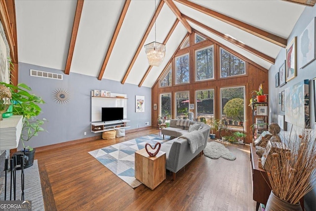 living area with high vaulted ceiling, beamed ceiling, wood finished floors, and a chandelier