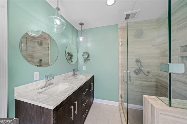 full bathroom featuring a shower stall, tile patterned flooring, baseboards, and double vanity