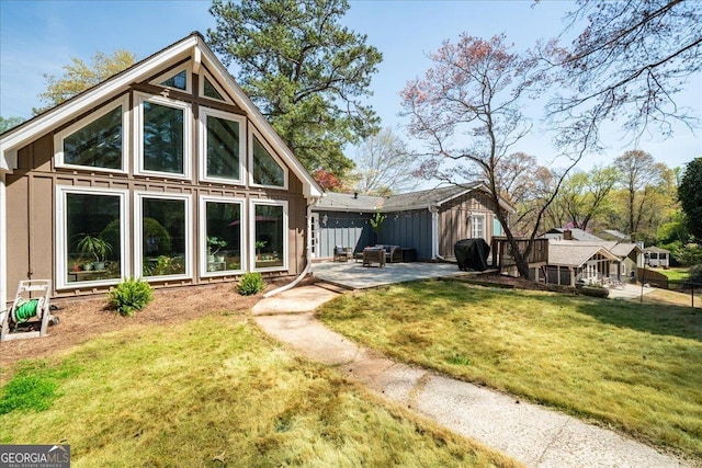 rear view of property with a patio and board and batten siding