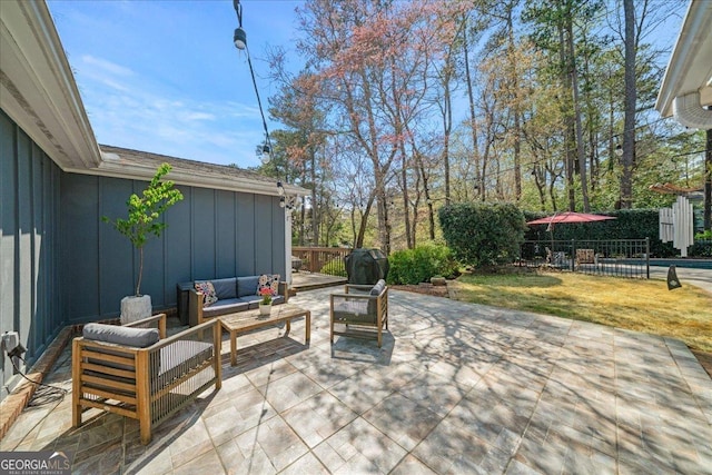 view of patio featuring an outdoor hangout area and fence