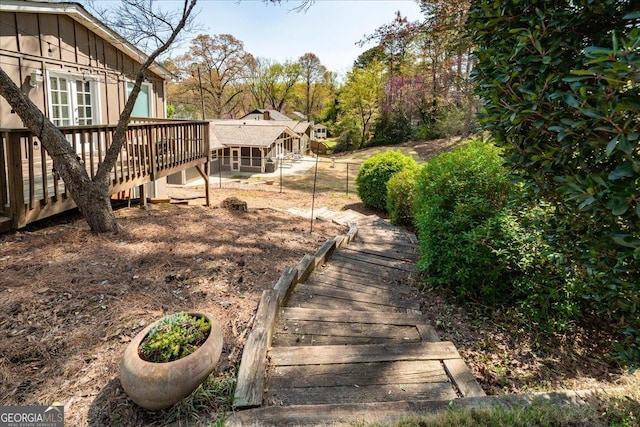 view of yard with a wooden deck and stairs