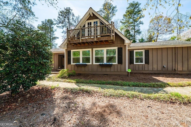 view of front of property featuring board and batten siding and a balcony