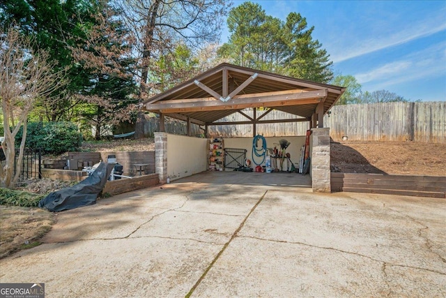 view of patio featuring driveway and a detached carport