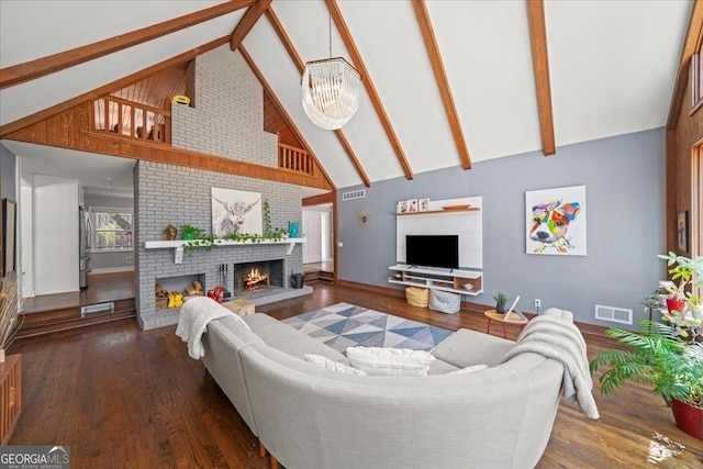 living area featuring high vaulted ceiling, a fireplace, baseboards, wood finished floors, and a chandelier