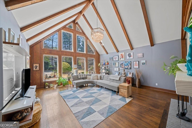 living room featuring high vaulted ceiling, beam ceiling, wood finished floors, a chandelier, and baseboards