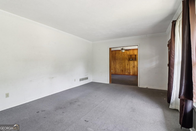 empty room featuring ornamental molding, visible vents, and carpet floors