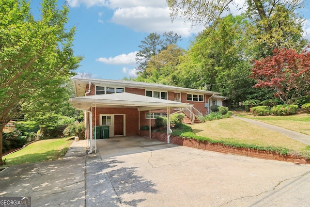 view of front of home featuring a carport, driveway, a front yard, and brick siding