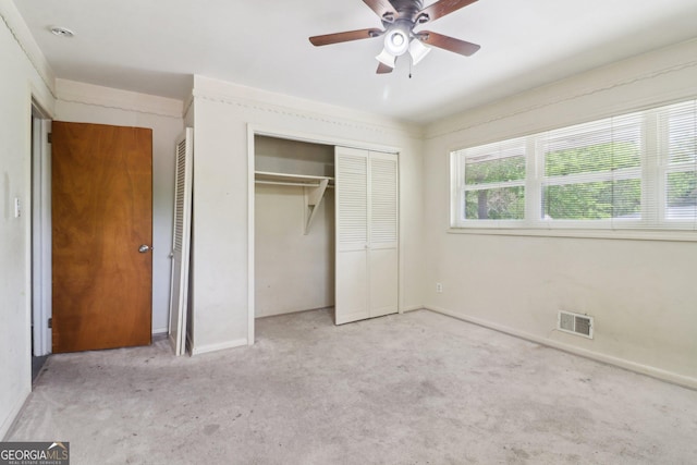unfurnished bedroom featuring visible vents, baseboards, a closet, a ceiling fan, and carpet floors