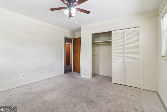 unfurnished bedroom with light carpet, a closet, and ceiling fan