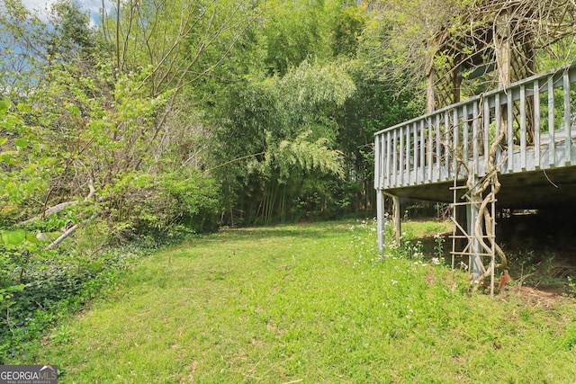 view of yard with a wooden deck