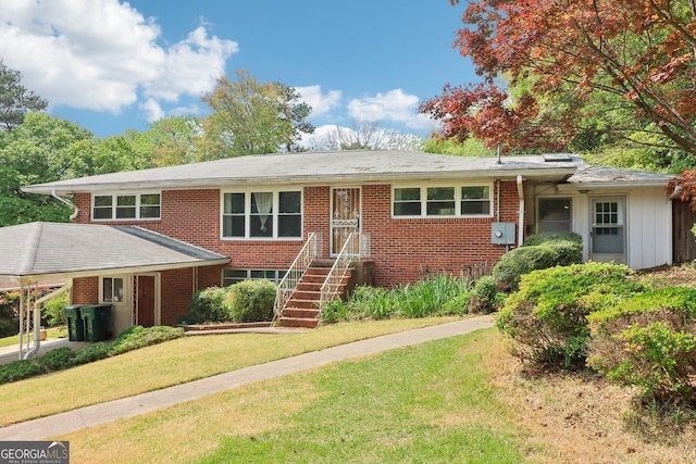 single story home with a front yard and brick siding