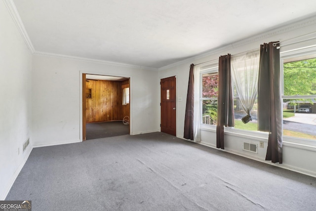 spare room featuring crown molding, carpet, and visible vents