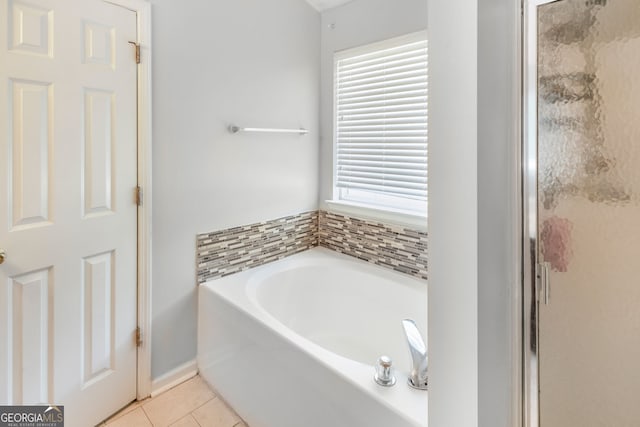 full bathroom featuring a shower stall, tile patterned floors, and a garden tub