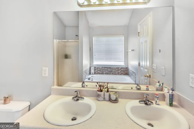 full bath featuring a sink, a shower stall, and double vanity