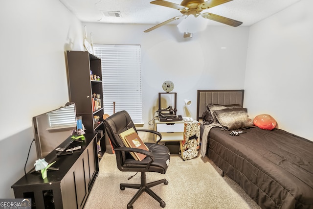carpeted bedroom with a ceiling fan and visible vents