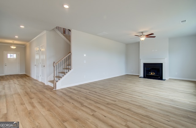 255 Arnewood Cir, Mcdonough, GA 30253 - unfurnished living room with stairway, a ceiling fan, light wood-style flooring, baseboards, and ornamental molding