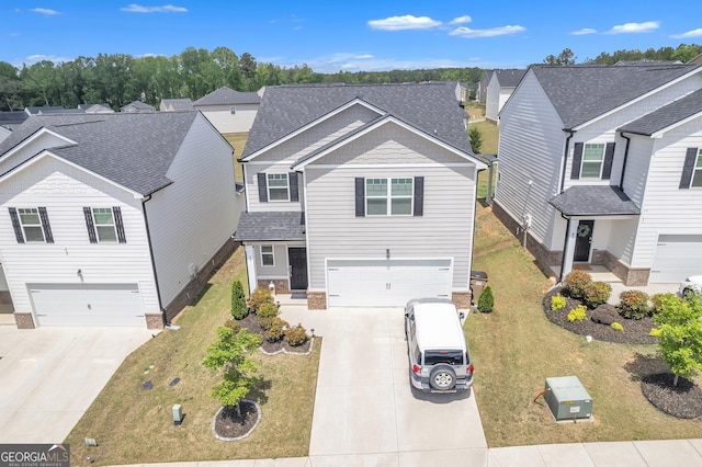 traditional home with a garage, concrete driveway, a front lawn, and a residential view