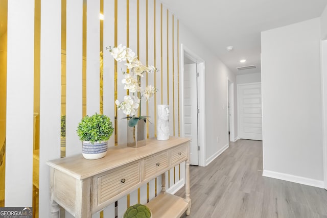 hall featuring baseboards, recessed lighting, wood finished floors, and visible vents