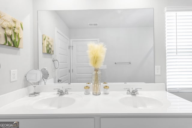 full bathroom featuring visible vents, a sink, and double vanity