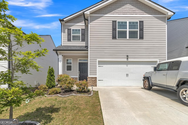 view of front of property with driveway, a front lawn, and a garage