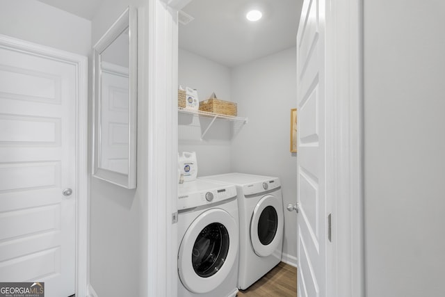 washroom featuring washing machine and clothes dryer, laundry area, recessed lighting, baseboards, and wood finished floors