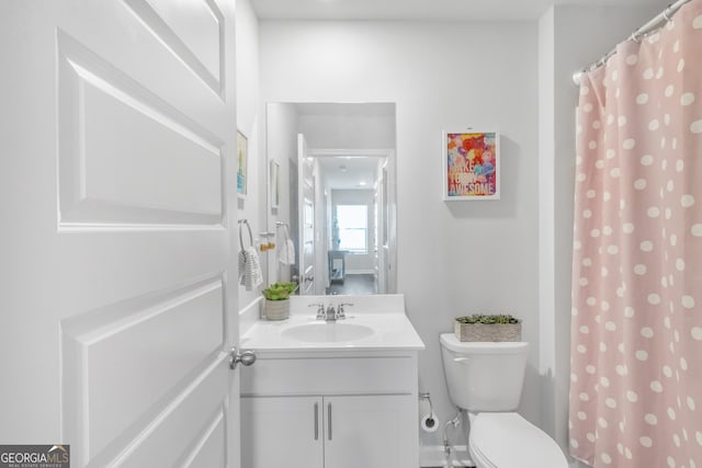 bathroom featuring vanity, a shower with curtain, and toilet