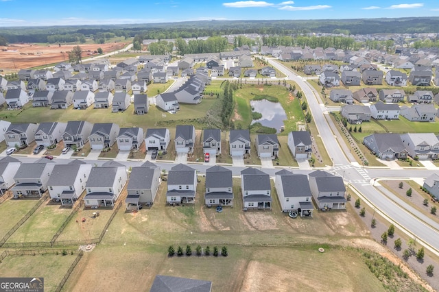 bird's eye view with a residential view and a water view