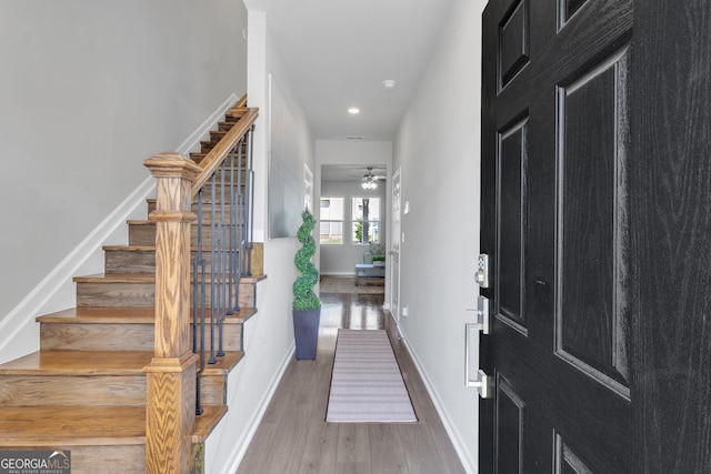 entryway with wood finished floors, baseboards, stairway, recessed lighting, and a ceiling fan