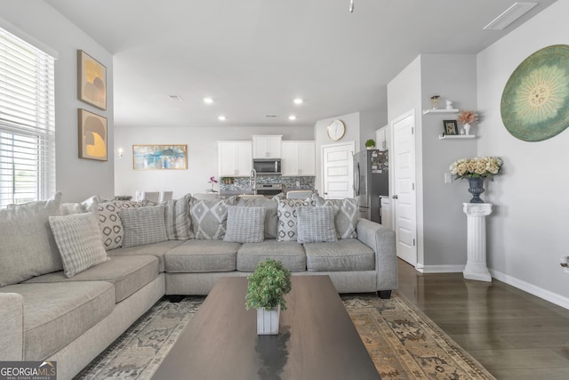living room featuring baseboards, recessed lighting, dark wood-style floors, and visible vents