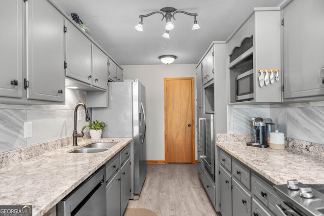 109 Shelton Ln, Eatonton, GA 31024 - kitchen with under cabinet range hood, a sink, range with electric stovetop, light wood finished floors, and gray cabinetry
