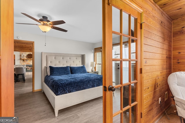 109 Shelton Ln, Eatonton, GA 31024 - bedroom with baseboards, a ceiling fan, access to exterior, french doors, and light wood-style flooring