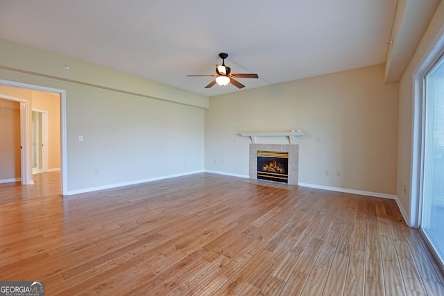 3112 Allison Ct, Young Harris, GA 30582 - unfurnished living room with a tiled fireplace, a ceiling fan, baseboards, and light wood finished floors
