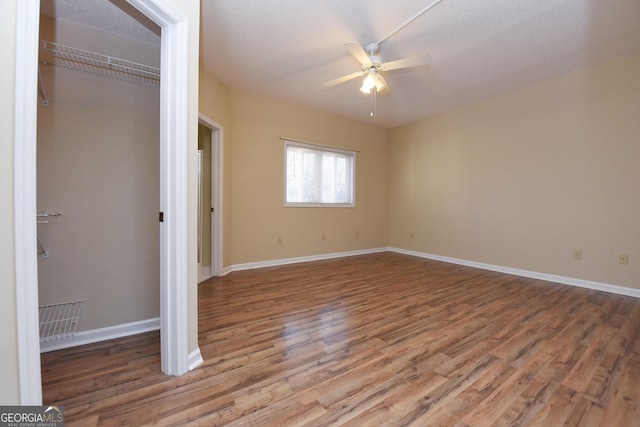 3112 Allison Ct, Young Harris, GA 30582 - unfurnished bedroom with a closet, a ceiling fan, wood finished floors, a textured ceiling, and baseboards