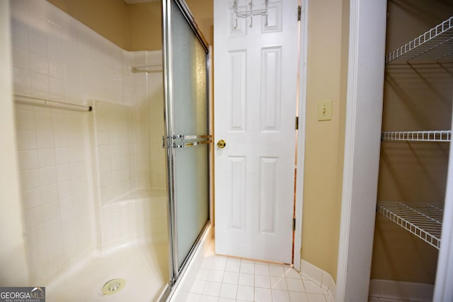3112 Allison Ct, Young Harris, GA 30582 - bathroom with baseboards, a spacious closet, tile patterned flooring, and a shower stall