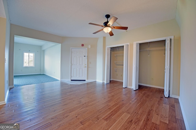 3112 Allison Ct, Young Harris, GA 30582 - unfurnished bedroom featuring baseboards, ceiling fan, two closets, and wood-type flooring