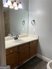 370 Rainey Dr, Dawsonville, GA 30534 - bathroom with baseboards, toilet, wood finished floors, vanity, and a notable chandelier