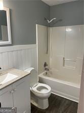 370 Rainey Dr, Dawsonville, GA 30534 - full bath with a wainscoted wall, toilet, wood finished floors, vanity, and shower / tub combination