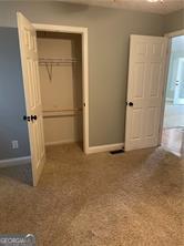 370 Rainey Dr, Dawsonville, GA 30534 - unfurnished bedroom featuring baseboards, a closet, and carpet flooring