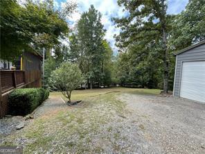370 Rainey Dr, Dawsonville, GA 30534 - view of yard with driveway and a garage