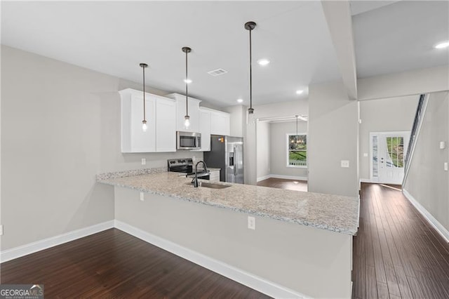 5726 Ridgewater Cir, Gainesville, GA 30506 - kitchen featuring baseboards, dark wood finished floors, a sink, a peninsula, and appliances with stainless steel finishes