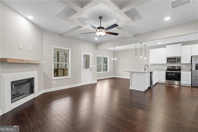 5726 Ridgewater Cir, Gainesville, GA 30506 - unfurnished living room with a fireplace, beamed ceiling, ceiling fan with notable chandelier, visible vents, and dark wood-style flooring