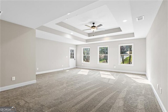 5726 Ridgewater Cir, Gainesville, GA 30506 - carpeted spare room with baseboards, a tray ceiling, a healthy amount of sunlight, and visible vents