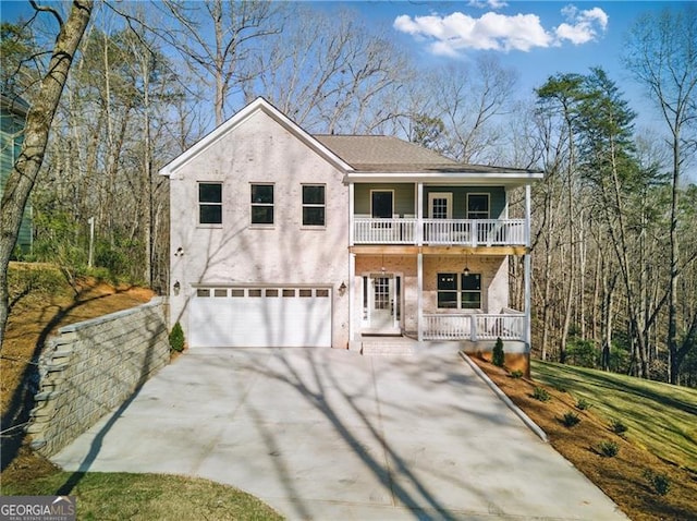5726 Ridgewater Cir, Gainesville, GA 30506 - view of front of property featuring a balcony, a garage, stucco siding, driveway, and a porch